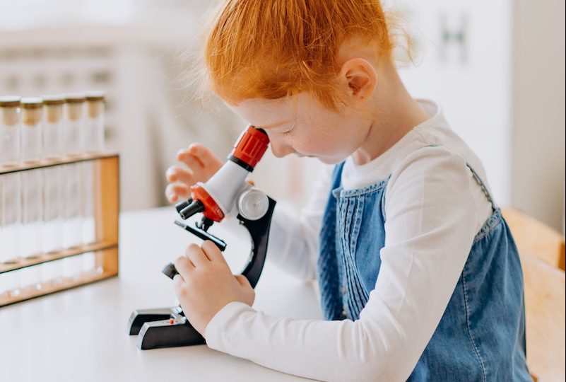 A Girl Using a Microscope