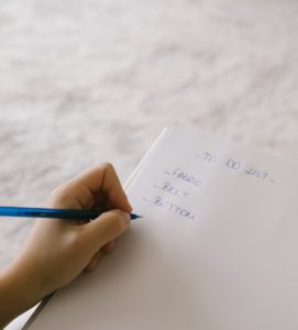 A Person Writing To Do List on White Paper